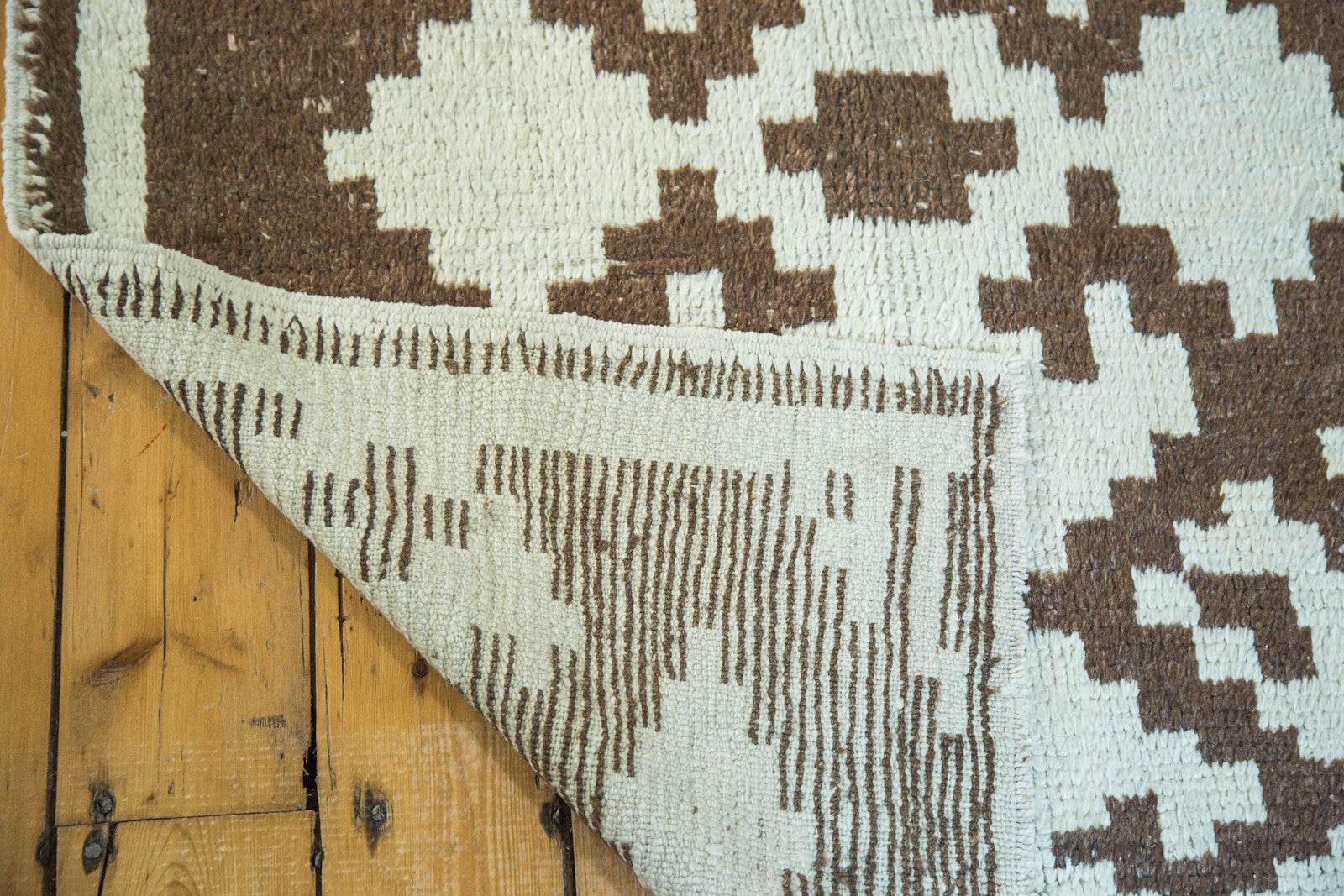 Woven reverse and shaggy geometric pile in pale ivory and brown on vintage Tulu rug.